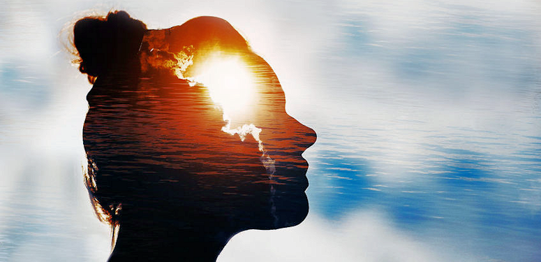 a woman's head with water in the background